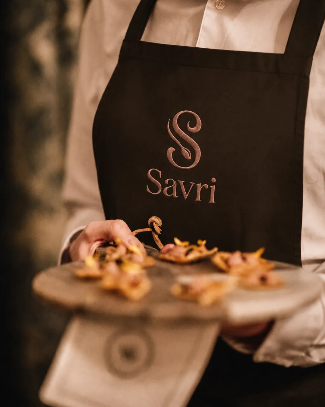 A Savri private chef presenting a freshly cooked dish